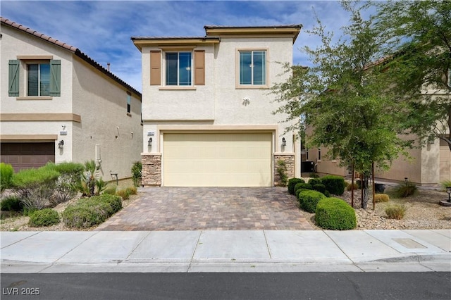 view of front facade with a garage, stucco siding, driveway, and stone siding