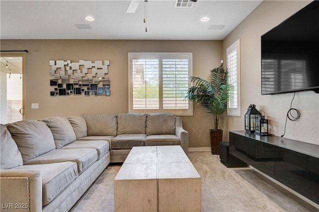 living room with a ceiling fan, recessed lighting, and baseboards