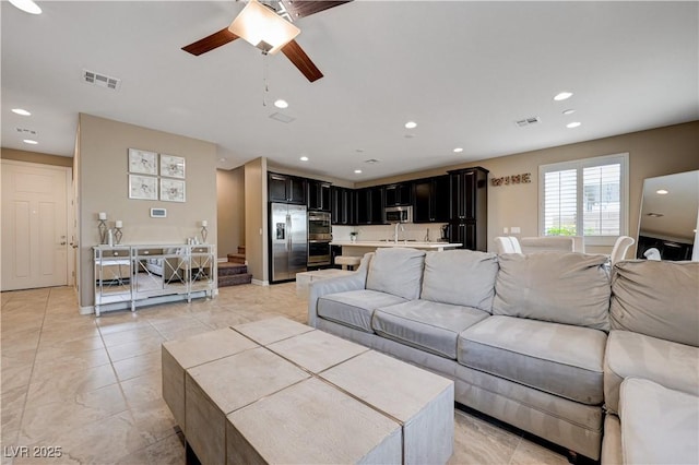 living area with a ceiling fan, recessed lighting, and light tile patterned floors