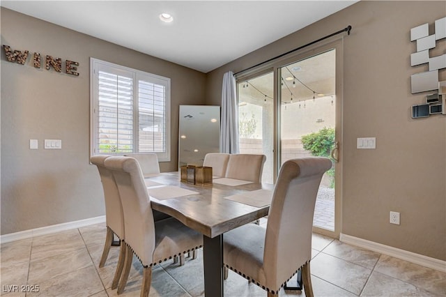 dining room featuring baseboards and recessed lighting