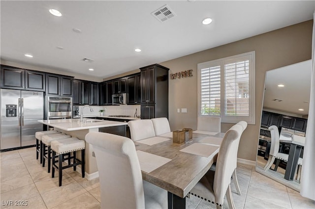 dining space with recessed lighting and baseboards