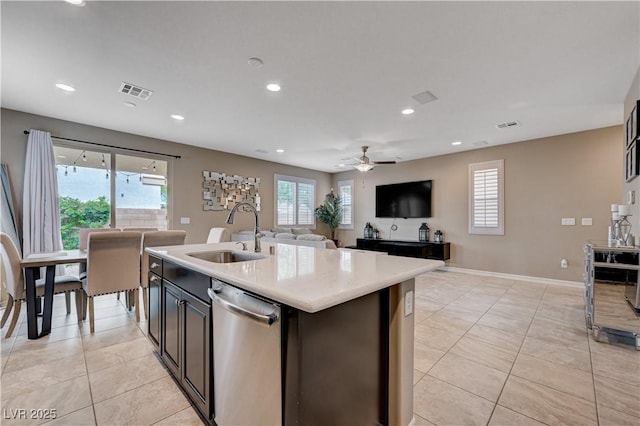 kitchen featuring a sink, dishwasher, light countertops, light tile patterned floors, and recessed lighting