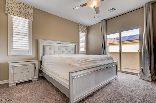 carpeted bedroom featuring access to exterior, multiple windows, a ceiling fan, and baseboards