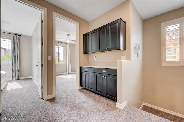 bar with light carpet, baseboards, and a ceiling fan