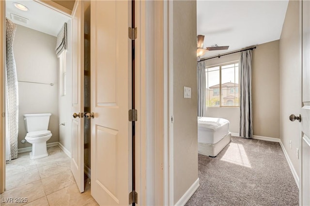bathroom with toilet and baseboards