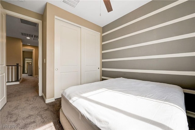 carpeted bedroom with a closet and a ceiling fan