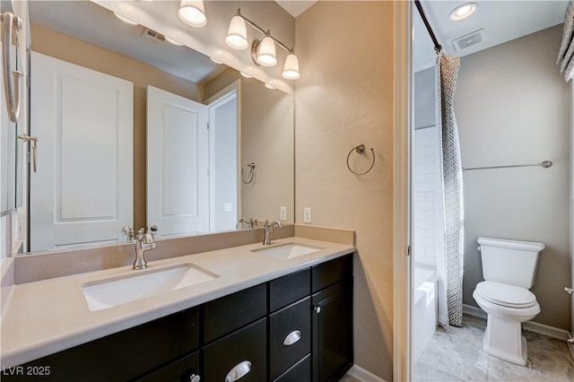 bathroom featuring double vanity, toilet, shower / bath combo with shower curtain, and baseboards