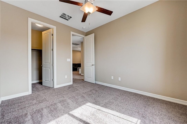 unfurnished bedroom featuring carpet, baseboards, and a ceiling fan