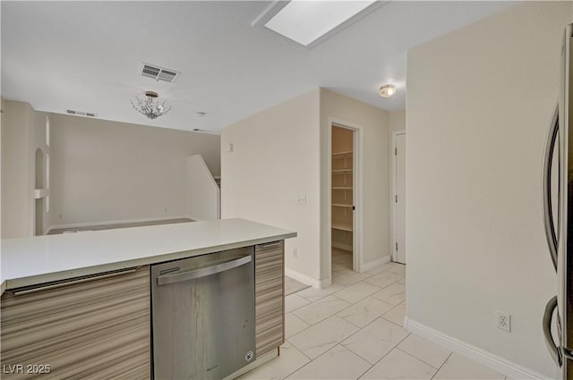 kitchen with stainless steel appliances, light marble finish floors, light countertops, and baseboards