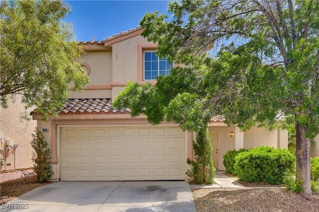 view of front of home featuring a tiled roof, driveway, and stucco siding