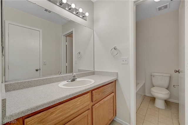 bathroom with vanity, tile patterned flooring, toilet, and baseboards