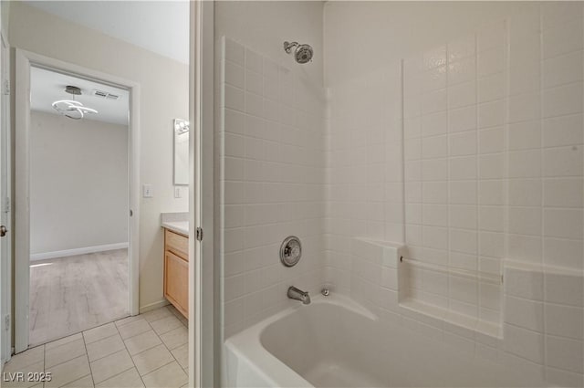 full bathroom with shower / bathtub combination, vanity, tile patterned flooring, and baseboards