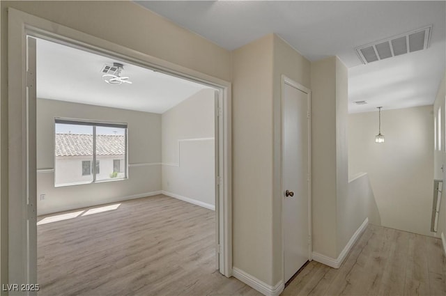 hall with wood finished floors and baseboards