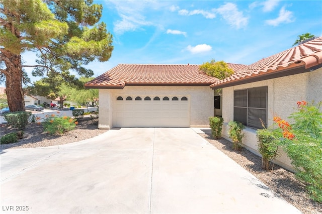4378 Cherrystone Ct, Las Vegas, NV 89121 - view of front of house featuring stucco siding, driveway, a tiled roof, and a garage