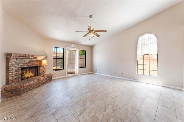 4378 Cherrystone Ct, Las Vegas, NV 89121 - unfurnished living room with a fireplace, a ceiling fan, and a textured ceiling