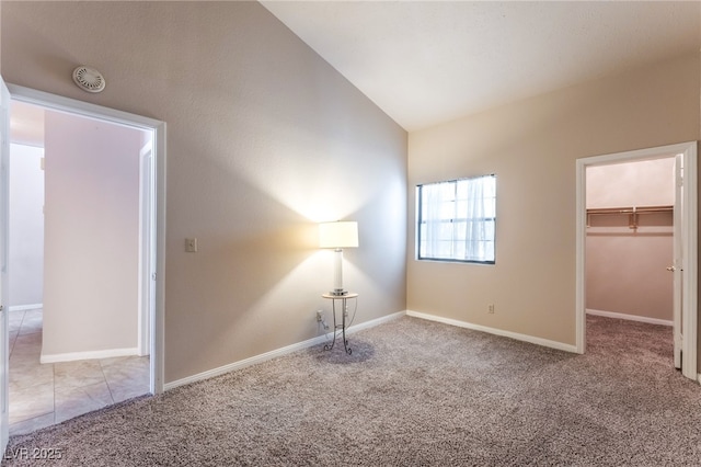 4378 Cherrystone Ct, Las Vegas, NV 89121 - unfurnished bedroom with carpet floors, a walk in closet, vaulted ceiling, and a closet
