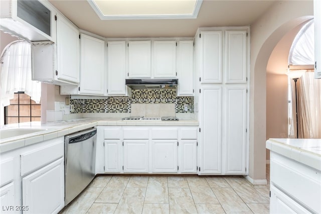 4378 Cherrystone Ct, Las Vegas, NV 89121 - kitchen with dishwasher, arched walkways, white cabinetry, and tasteful backsplash