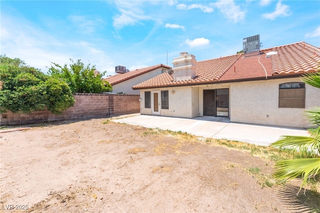 4378 Cherrystone Ct, Las Vegas, NV 89121 - back of house with a tiled roof, a chimney, stucco siding, and a patio