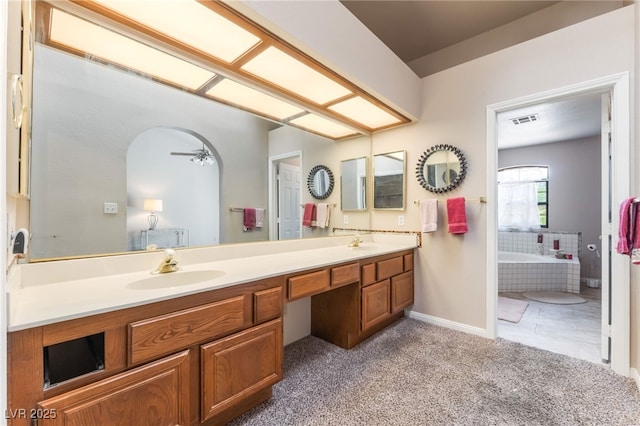 4378 Cherrystone Ct, Las Vegas, NV 89121 - bathroom with double vanity, a bath, a ceiling fan, and carpet flooring