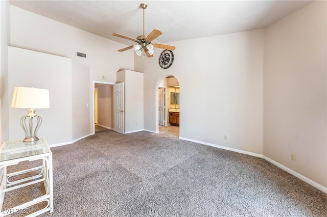 4378 Cherrystone Ct, Las Vegas, NV 89121 - unfurnished bedroom featuring carpet floors, arched walkways, vaulted ceiling, ensuite bath, and a ceiling fan