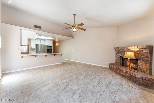 4378 Cherrystone Ct, Las Vegas, NV 89121 - unfurnished living room with ceiling fan, a fireplace, and lofted ceiling