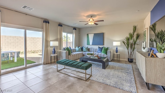 living room featuring a ceiling fan and tile patterned flooring