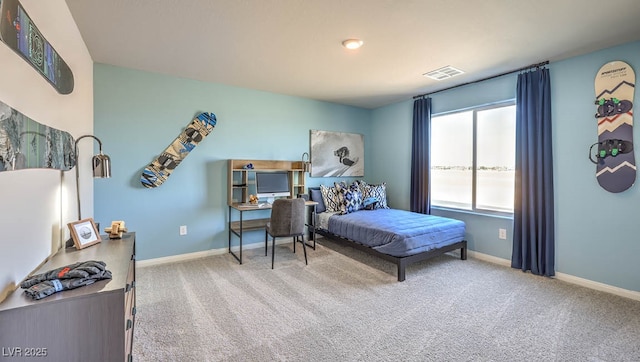 bedroom with carpet floors, baseboards, and an office area