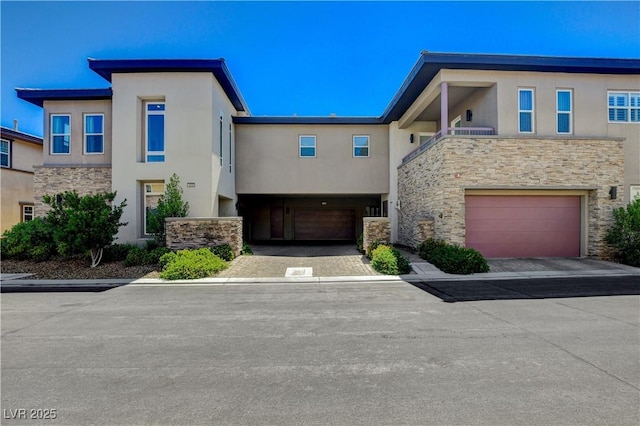 11280 Granite Ridge Dr Unit 1035, Las Vegas, NV 89135 - view of front facade with stone siding, stucco siding, and a garage