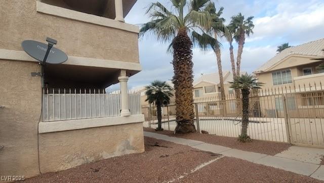 1830 N Pecos Rd Unit 155, Las Vegas, NV 89115 - view of side of property featuring fence and stucco siding