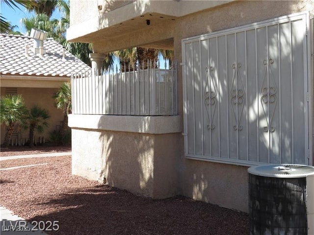 1830 N Pecos Rd Unit 155, Las Vegas, NV 89115 - view of side of home featuring stucco siding, a tile roof, and central AC