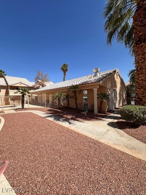 1830 N Pecos Rd Unit 155, Las Vegas, NV 89115 - rear view of house with stucco siding and a tiled roof