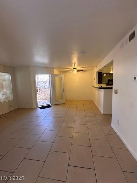 1830 N Pecos Rd Unit 155, Las Vegas, NV 89115 - spare room with light tile patterned floors, a ceiling fan, and baseboards