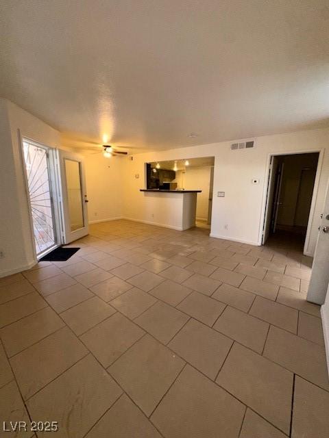 1830 N Pecos Rd Unit 155, Las Vegas, NV 89115 - unfurnished living room with light tile patterned floors and baseboards
