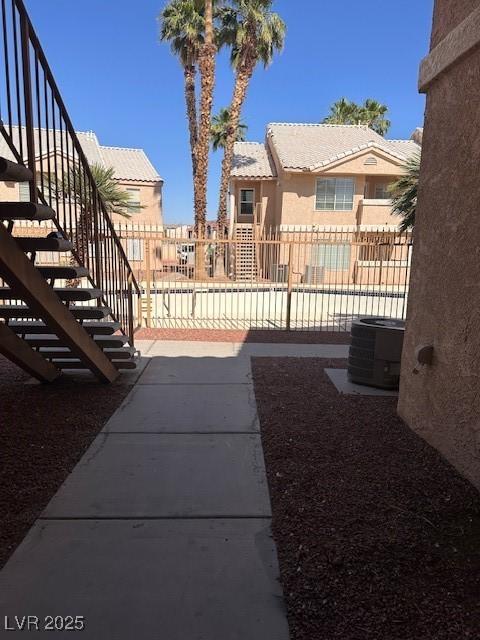 1830 N Pecos Rd Unit 155, Las Vegas, NV 89115 - view of yard featuring cooling unit, stairs, and a residential view