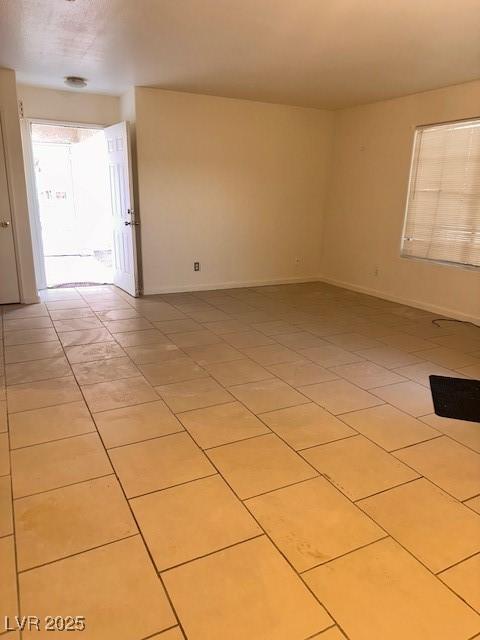 1830 N Pecos Rd Unit 155, Las Vegas, NV 89115 - spare room featuring light tile patterned flooring and baseboards