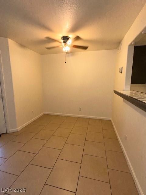 1830 N Pecos Rd Unit 155, Las Vegas, NV 89115 - unfurnished room with a ceiling fan, light tile patterned floors, a textured ceiling, and baseboards
