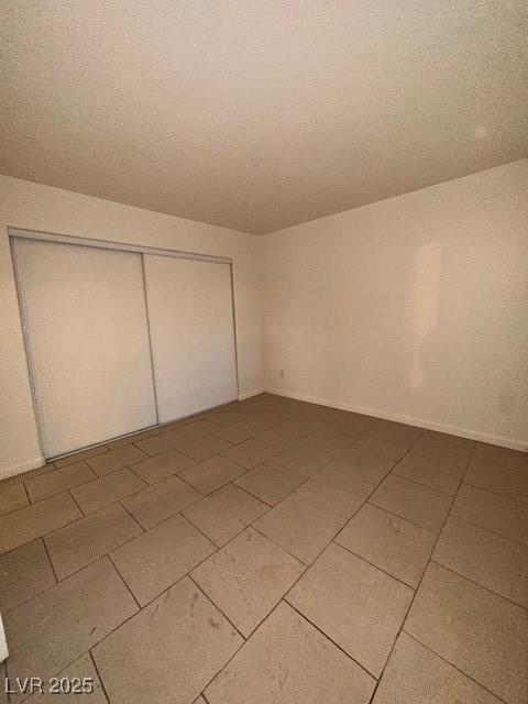 1830 N Pecos Rd Unit 155, Las Vegas, NV 89115 - unfurnished bedroom with a closet and light tile patterned floors