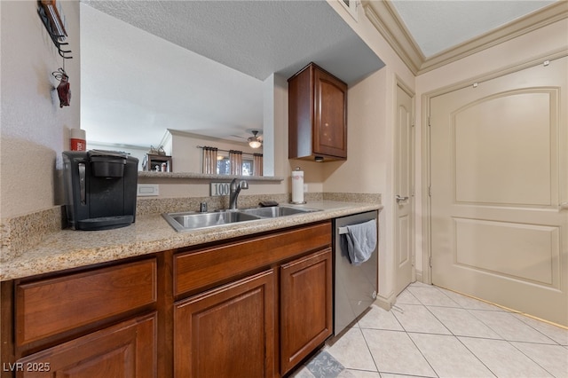 kitchen with dishwasher, a sink, light tile patterned floors, light countertops, and brown cabinets