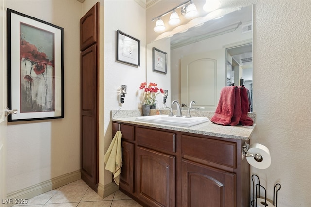 bathroom featuring tile patterned floors, vanity, and baseboards