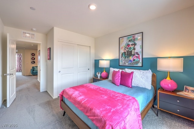carpeted bedroom featuring a closet and baseboards