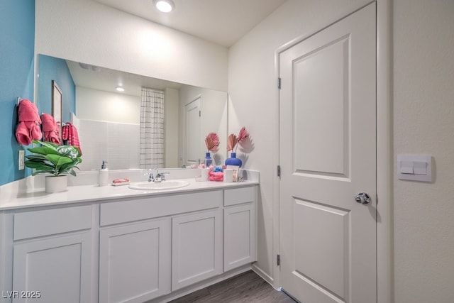 bathroom with vanity and wood finished floors