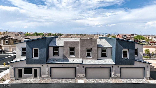 view of property with stucco siding and a garage