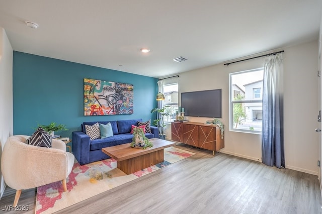 living area featuring wood finished floors and baseboards