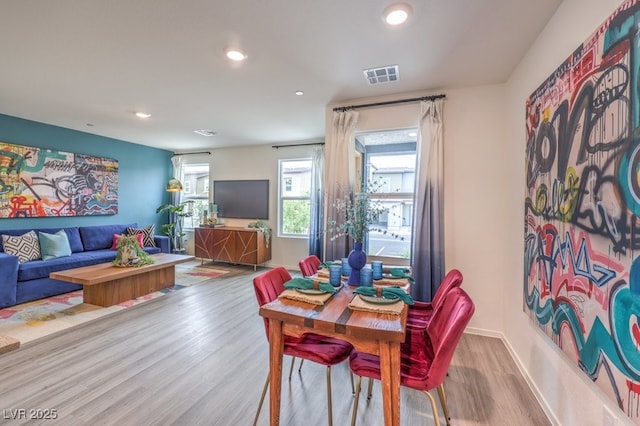 dining room featuring wood finished floors, recessed lighting, and baseboards