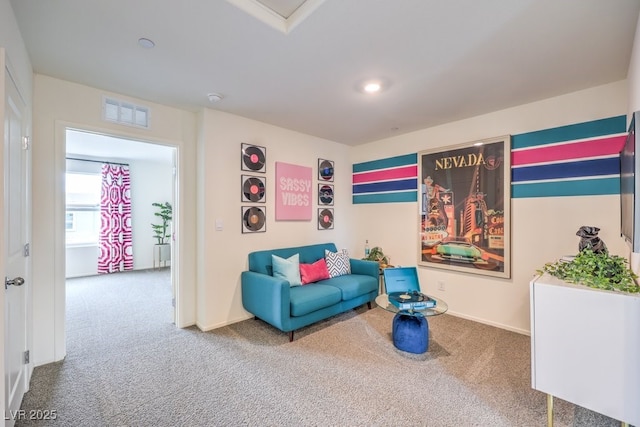 living area featuring carpet floors and baseboards