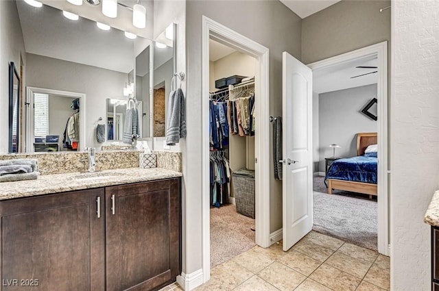 2159 Morro Vista Dr, Las Vegas, NV 89135 - ensuite bathroom featuring vanity, tile patterned floors, and a spacious closet