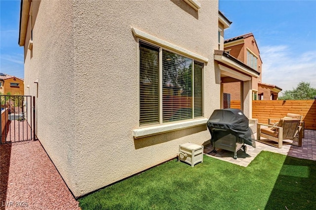2159 Morro Vista Dr, Las Vegas, NV 89135 - rear view of property with stucco siding, a patio area, fence, and an outdoor living space
