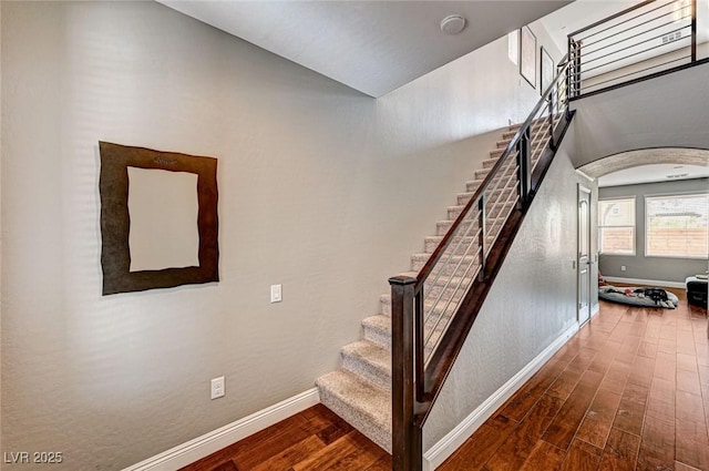 2159 Morro Vista Dr, Las Vegas, NV 89135 - stairway with baseboards, wood finished floors, and arched walkways