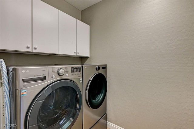2159 Morro Vista Dr, Las Vegas, NV 89135 - clothes washing area featuring cabinet space, washing machine and dryer, a textured wall, and baseboards