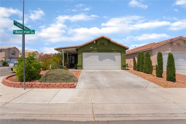 view of front facade with concrete driveway, a garage, and stucco siding